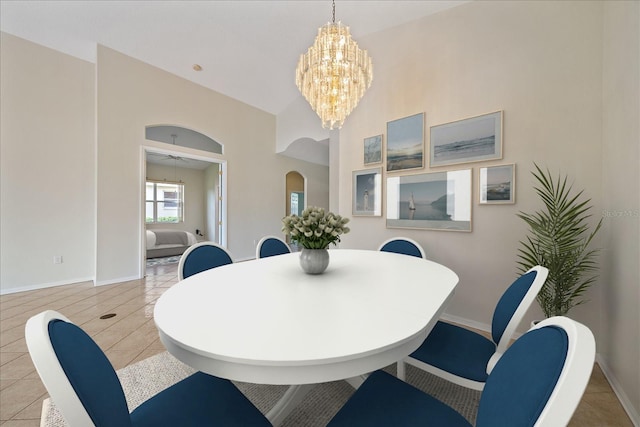 dining space featuring ceiling fan with notable chandelier and light tile patterned floors