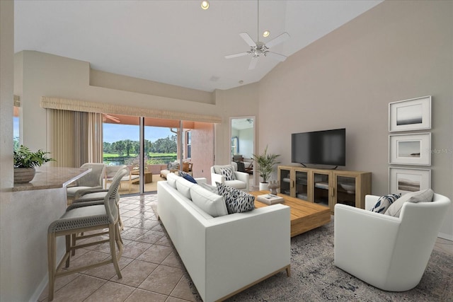 living room featuring ceiling fan, light tile patterned floors, and high vaulted ceiling