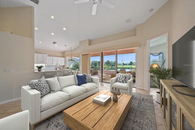 tiled living room featuring high vaulted ceiling, ceiling fan, and sink