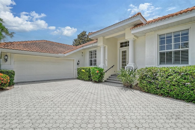 mediterranean / spanish home featuring a garage