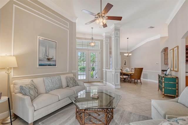 living room featuring tile floors, ornamental molding, ceiling fan with notable chandelier, and french doors