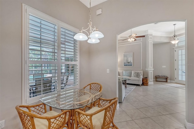 tiled dining space featuring ceiling fan with notable chandelier and ornamental molding