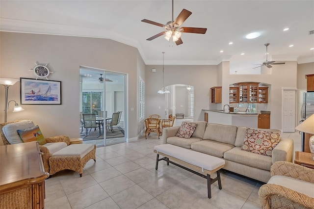 tiled living room with vaulted ceiling, sink, ceiling fan, and crown molding