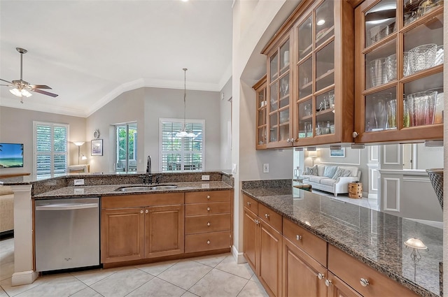 kitchen featuring dark stone counters, sink, ceiling fan, and stainless steel dishwasher