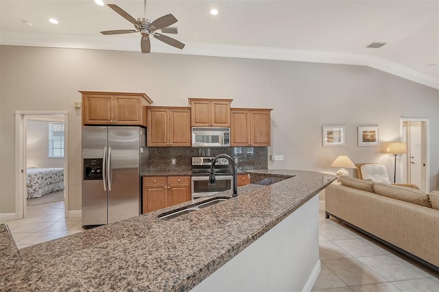 kitchen featuring ceiling fan, crown molding, tasteful backsplash, stainless steel appliances, and light tile floors