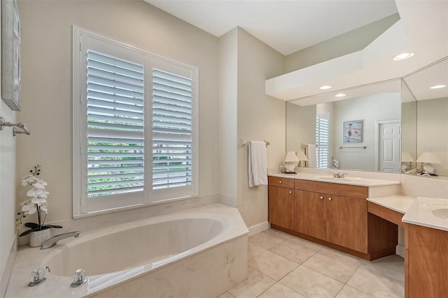 bathroom with double vanity, tile floors, and a bathing tub