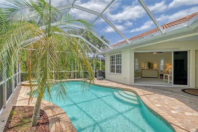 view of pool featuring a patio and glass enclosure