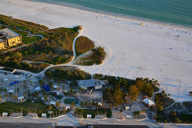 drone / aerial view with a beach view and a water view