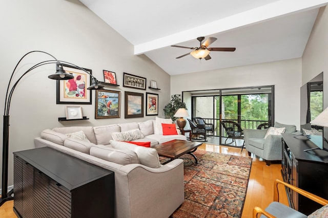 living room with vaulted ceiling with beams, ceiling fan, and light wood-type flooring