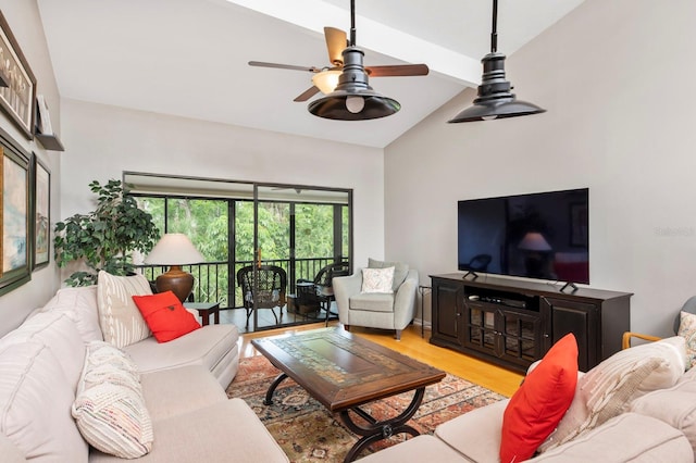 living room with vaulted ceiling with beams, ceiling fan, and light wood-type flooring