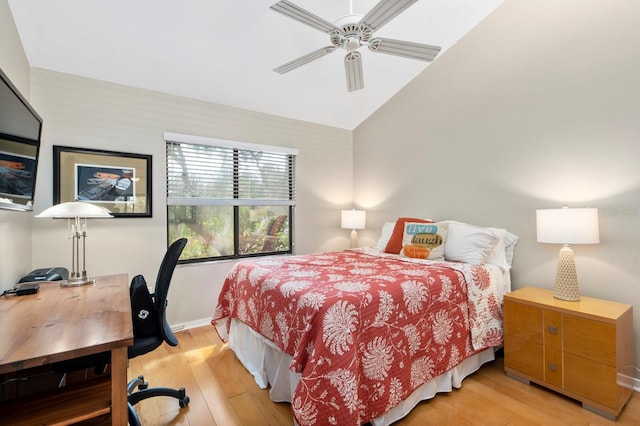 bedroom with light hardwood / wood-style floors, ceiling fan, and lofted ceiling