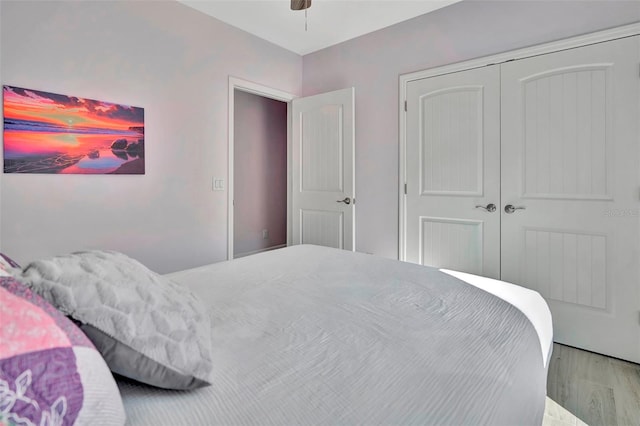 bedroom with a closet, ceiling fan, and light hardwood / wood-style flooring