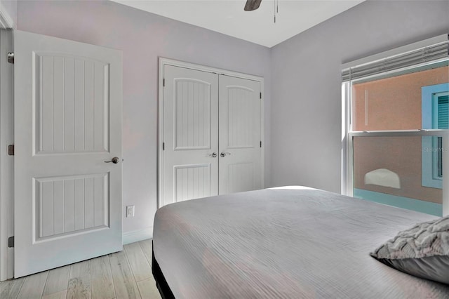 bedroom with a closet, ceiling fan, and light hardwood / wood-style flooring