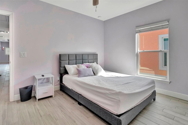 bedroom with ceiling fan and light hardwood / wood-style flooring