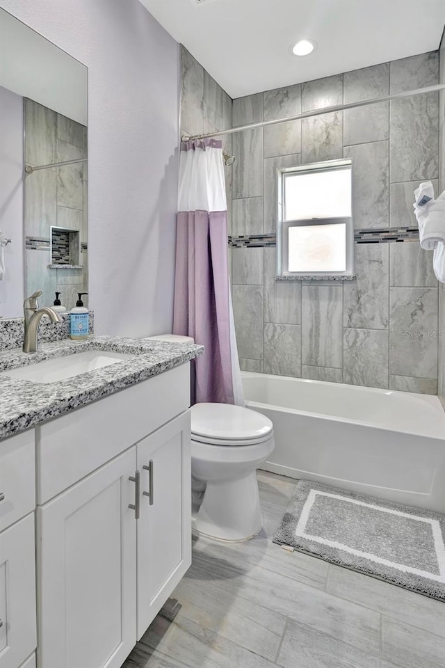 full bathroom with tile floors, shower / bath combo, toilet, and vanity