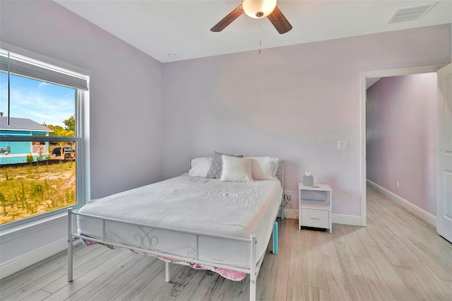 bedroom featuring light wood-type flooring and ceiling fan