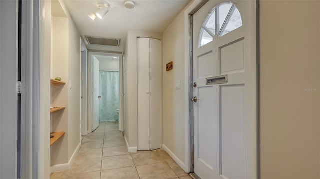 corridor featuring light tile flooring