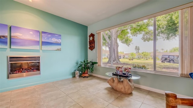 living area featuring a healthy amount of sunlight and light tile flooring