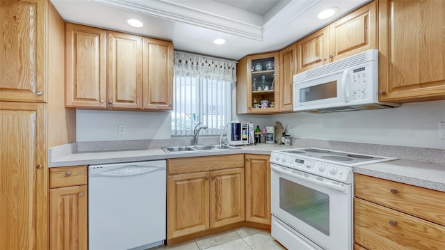 kitchen with sink, light tile flooring, and white appliances