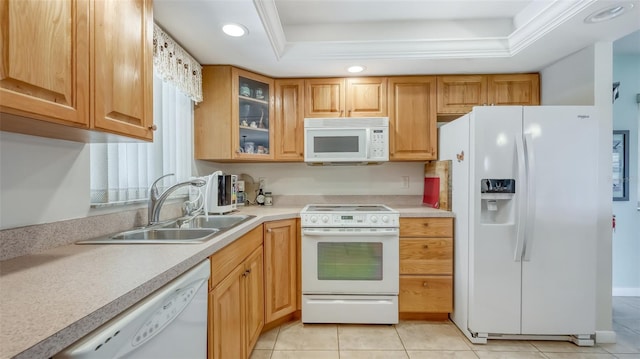 kitchen featuring light tile floors, sink, white appliances, and a tray ceiling