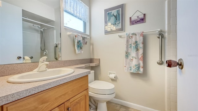 bathroom featuring tile flooring, toilet, and large vanity