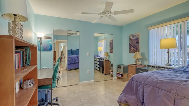 tiled bedroom with multiple closets and ceiling fan