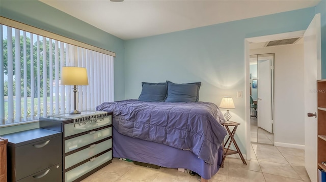 tiled bedroom featuring a closet