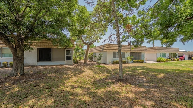 rear view of property with a yard