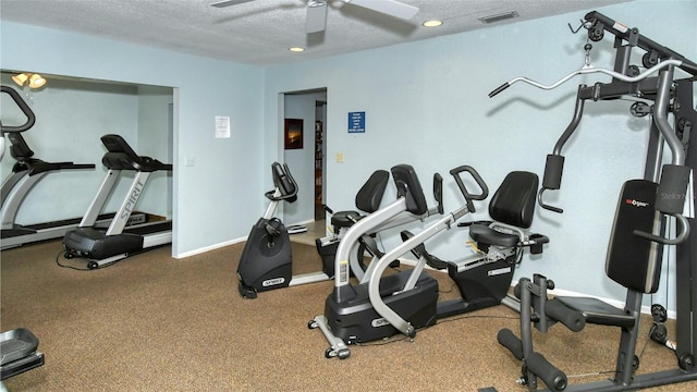 workout area with ceiling fan and a textured ceiling