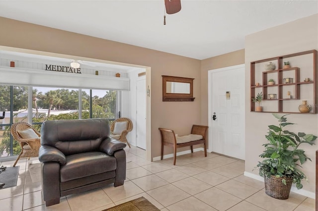 living area with ceiling fan and light tile flooring