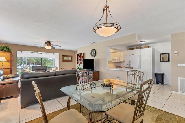 tiled dining space featuring ceiling fan