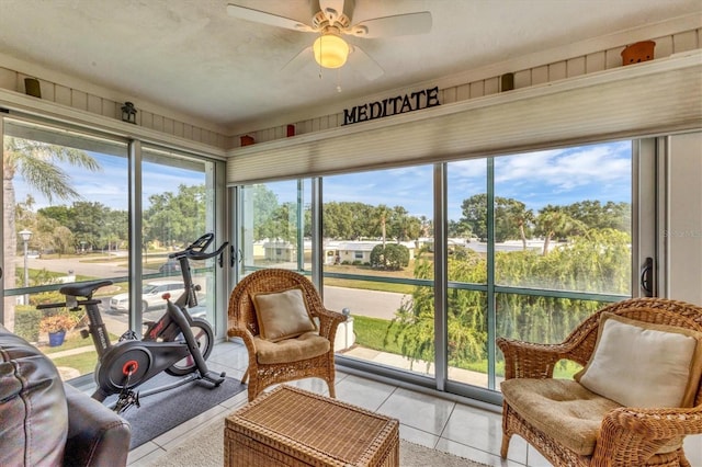 sunroom featuring ceiling fan