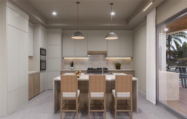 kitchen with wall oven, backsplash, a raised ceiling, black microwave, and sink