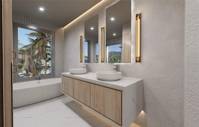 bathroom with a washtub and vanity