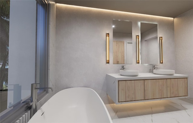 bathroom featuring a washtub and vanity