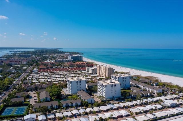 bird's eye view with a water view and a beach view