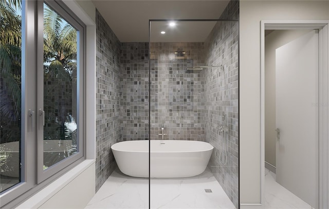 bathroom featuring tile walls and independent shower and bath