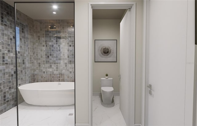 bathroom featuring a tub to relax in, toilet, and tile walls