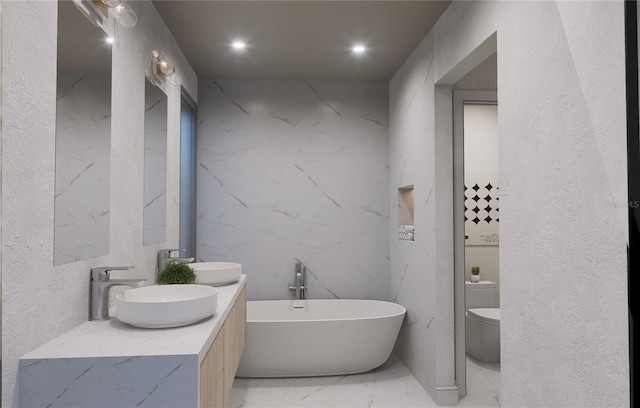 bathroom with a bathing tub, vanity, and toilet