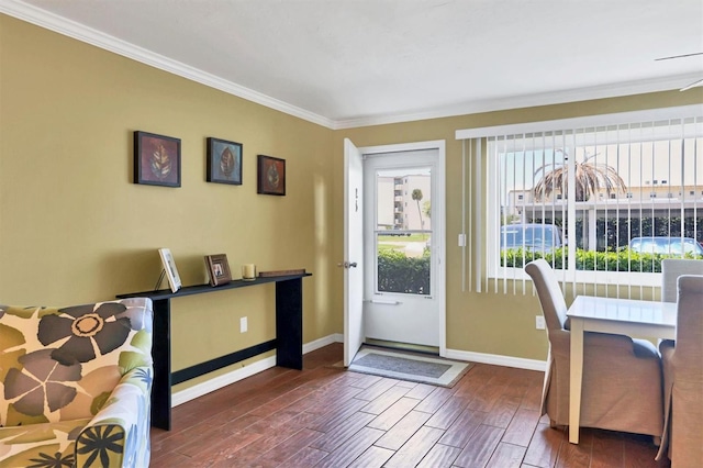 foyer entrance with dark hardwood / wood-style flooring and crown molding