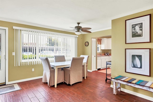 dining room featuring dark hardwood / wood-style flooring, ceiling fan, crown molding, and sink