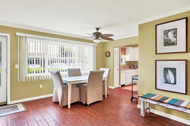 dining space featuring a ceiling fan, dark wood-style floors, baseboards, and crown molding