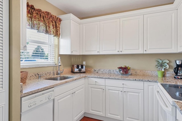 kitchen with white cabinets, a sink, and white appliances