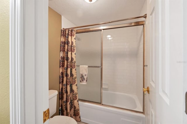bathroom featuring toilet and shower / bath combination with glass door