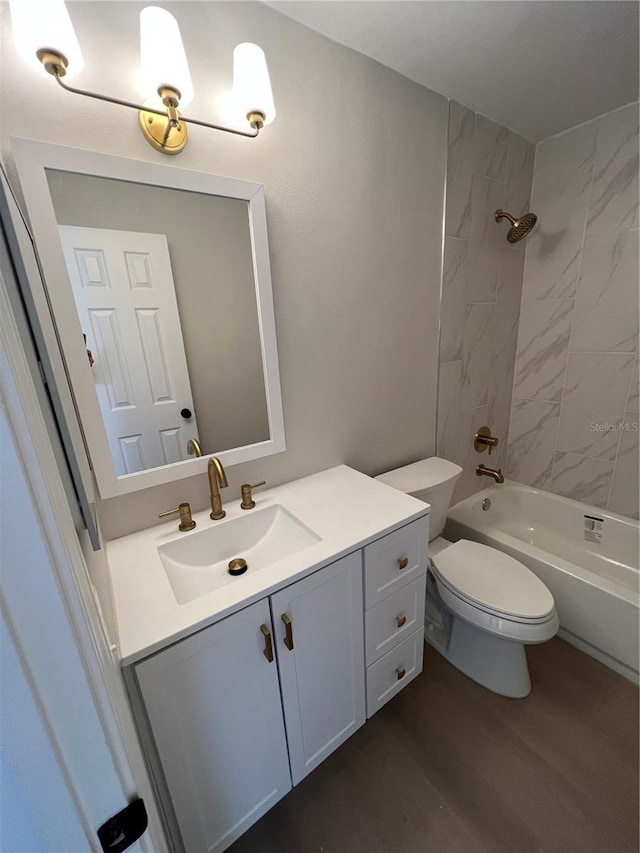 full bathroom with tiled shower / bath combo, wood-type flooring, vanity, and toilet