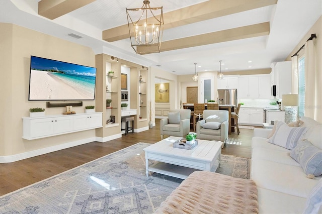 living room with built in features, a chandelier, and dark hardwood / wood-style floors