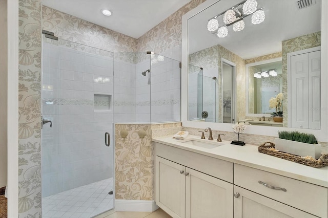 bathroom with vanity and a shower with shower door