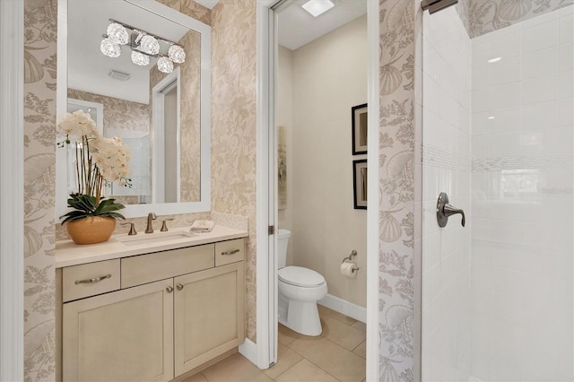 bathroom with a shower, tile patterned floors, vanity, and toilet