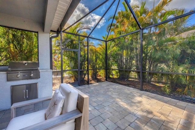 view of patio / terrace featuring area for grilling and a lanai