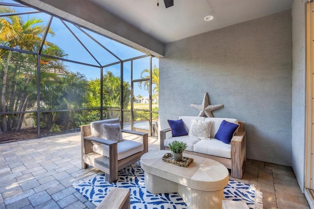 view of patio / terrace featuring glass enclosure and an outdoor living space